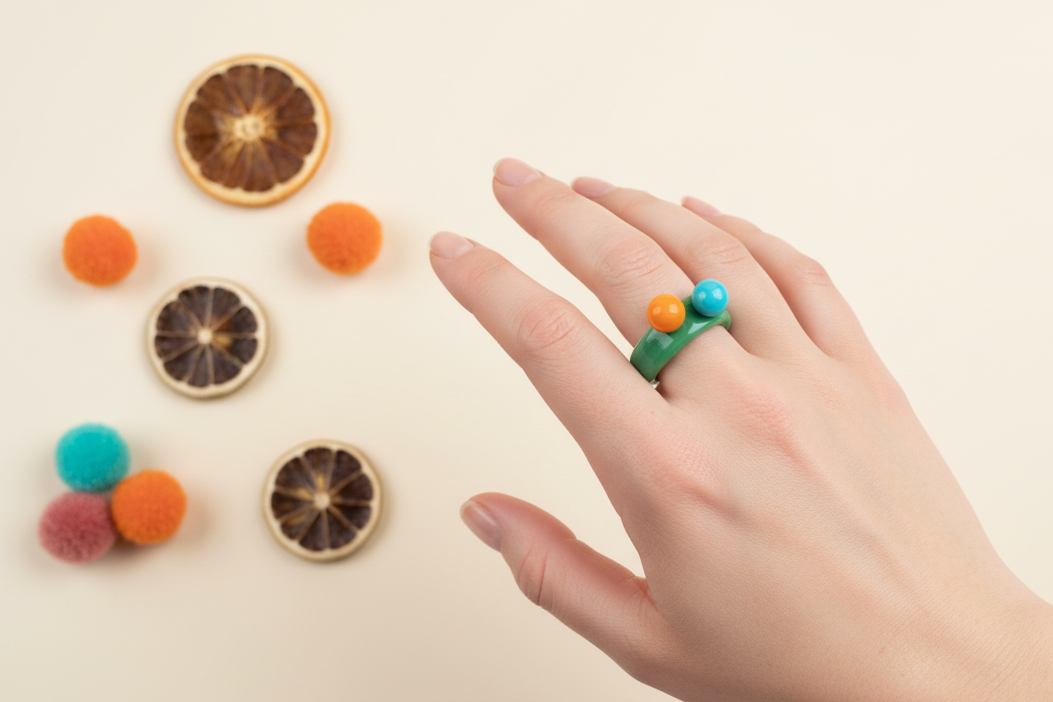 Green glass ring with elegant hand and clean background