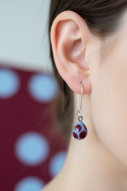 Playful ear photo with burgundy and blue polka dot glass earring